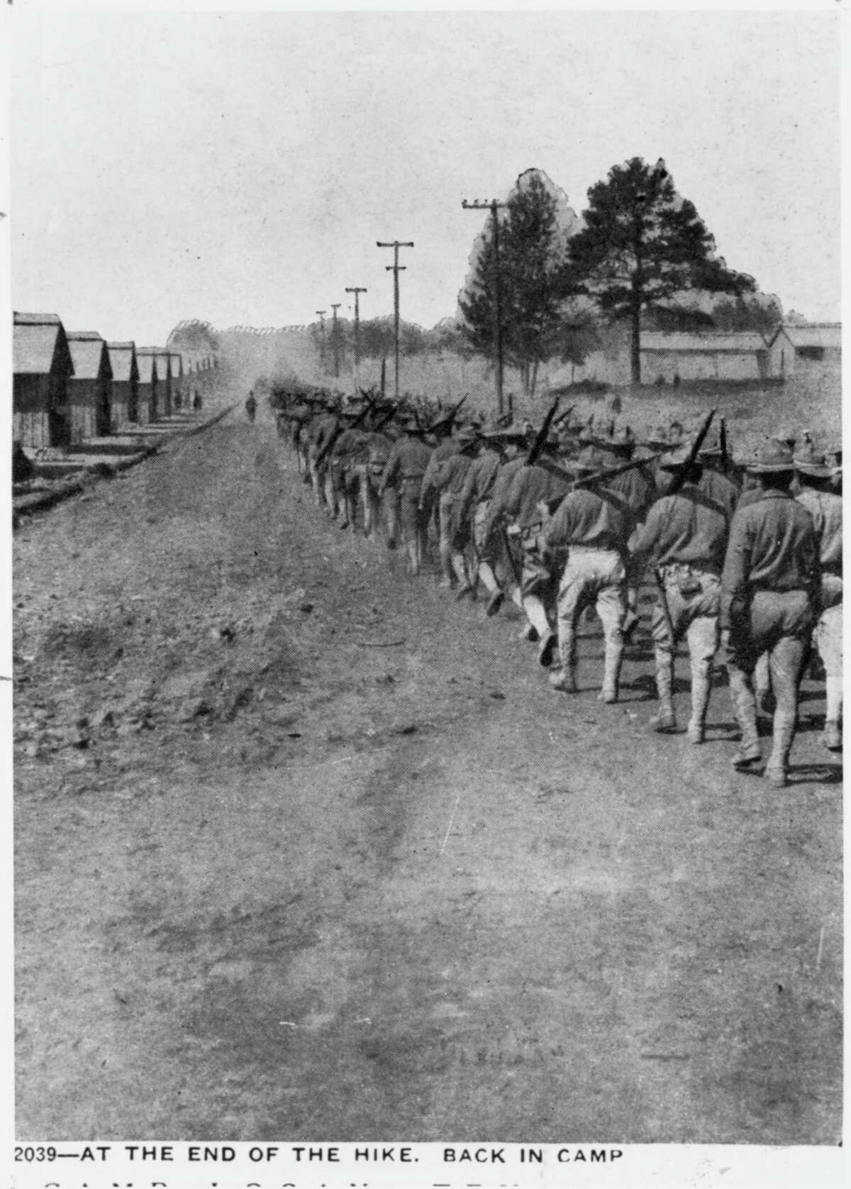 Soldiers in training for service in World War 1, heading back to Camp Logan after a hike through the area that is now known as Memorial Park. This photograph is among those belonging to the Houston Public Library that chronicle the history of Houston.
