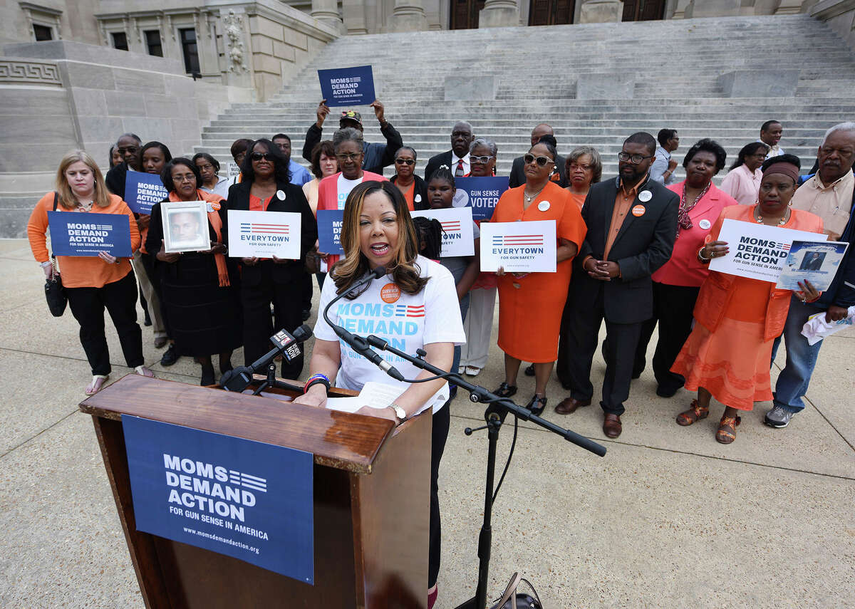FILE- In this March 17, 2016, file photo, Lucy McBath, National Spokeswoman for Moms Demand Action for Gun Sense in America, is joined by faith leaders, gun violence survivors and others on the south steps of the Mississippi State Capitol in Jackson, Miss. McBath is afraid many more people will die if Florida Gov. Rick Scott signs a bill making it harder to prosecute when people claim they commit violence in self-defense. She already lost her son, an unarmed black teenager, when a white man angry over loud music and claiming self-defense fired at an SUV filled with teenagers. The measure before Scott would effectively require a trial-before-a-trial whenever someone invokes self-defense, making prosecutors prove the suspect doesnÂ?’t deserve immunity. (Joe Ellis/The Clarion-Ledger via AP, File)