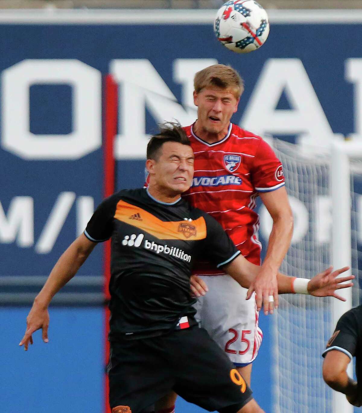Walker Zimmerman (25) of FC Dallas gets up over Dynamo forward Erick Torres (9) for a header in the first half.