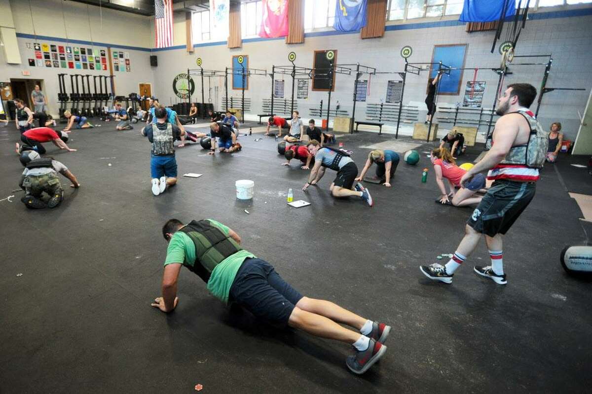 CrossFitters do push-ups as part of the Michael Murphy Memorial Day workout inside Stamford's CrossFit Affinity in Stamford, Conn. on Monday, May 29, 2017. CrossFit locations across the country honored Navy Seal Michael Murphy, who was killed in Afghanistan in 2005, by completing his favorite work out aptly nicknamed 'The Murph' and includes a one mile run, 100 pullups, 200 pushups, 300 squats and a final one mile run.