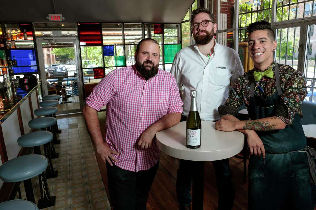 Terry Williams, left, Justin Vann, and Alex Negranza pose for a photo with a bottle of Clotilde Davenne Brut Extra Cremant De Bourgogne at Better Luck Tomorrow on Wednesday, May 24, 2017, in Houston. ( Brett Coomer / Houston Chronicle )