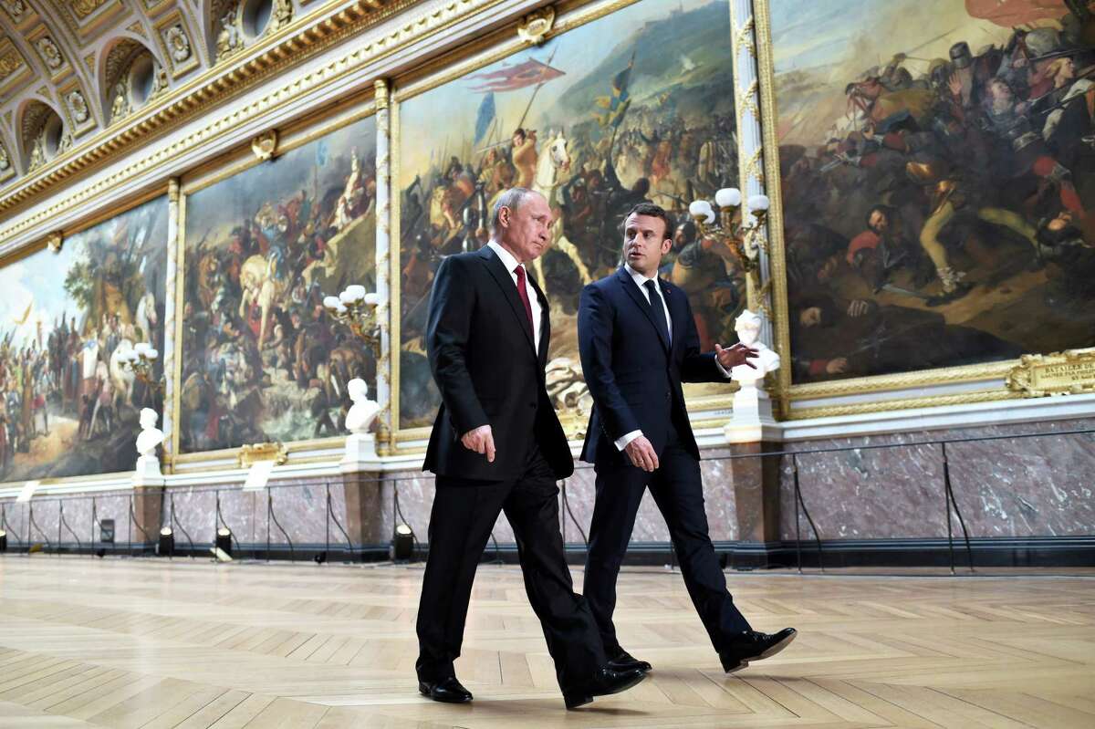French President Emmanuel Macron, right, speaks to Russian President Vladimir Putin in the Galerie des Batailles (Gallery of Battles) at the Versailles Palace as they arrive for a joint press conference following their meeting in Versailles, near Paris, France, Monday, May 29, 2017. Monday's meeting comes in the wake of the Group of Seven's summit over the weekend where relations with Russia were part of the agenda, making Macron the first Western leader to speak to Putin after the talks. (Stephane de Sakutin/Pool Photo via AP)