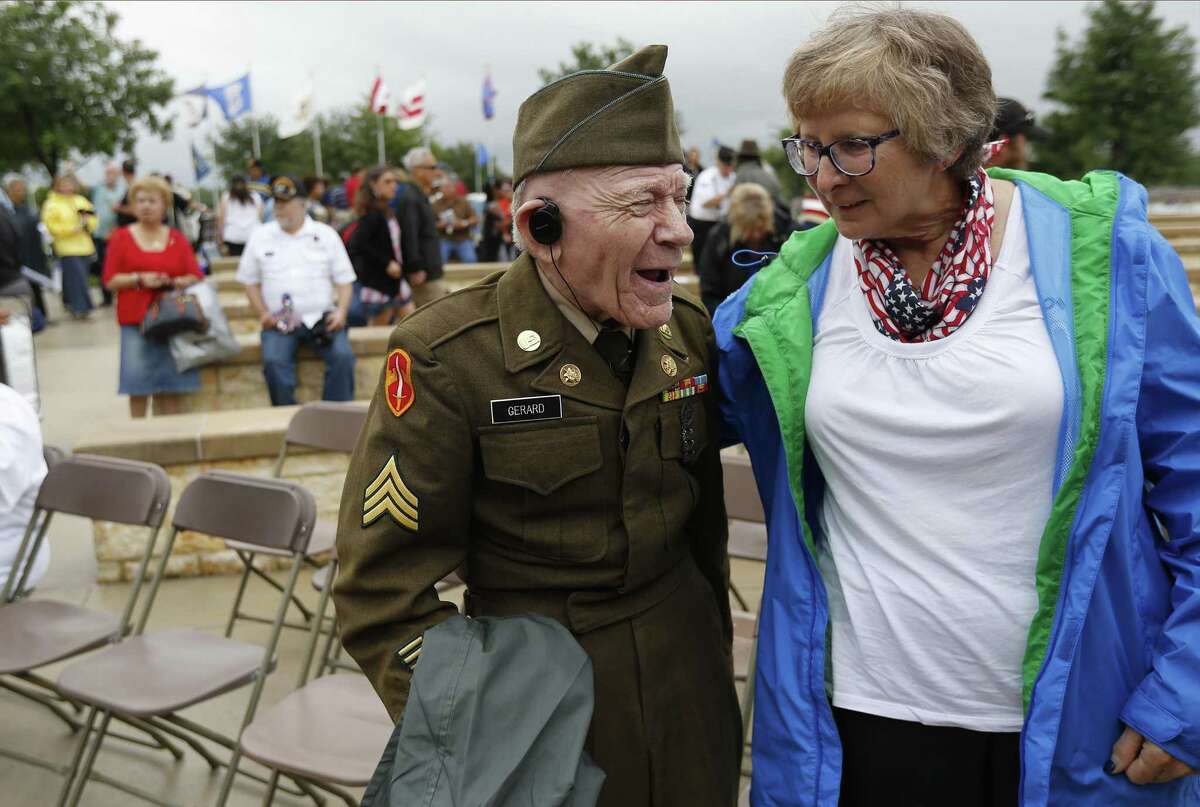 Korean War veteran Sgt. James Francis Joseph Gerard shares a lighter moment with Millie Goodman Kralich (right) at the conclusion of the Memorial Day ceremony at Fort Sam Houston National Cemetery on Monday, May 29, 2017. (Kin Man Hui/San Antonio Express-News)