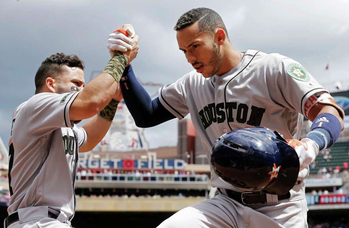Houston Astros' Carlos Correa, right, is congratulated by Jose Altuve following his solo home run off Minnesota Twins pitcher Ervin Santana, left, in the fourth inning of a baseball game Monday, May 29, 2017, in Minneapolis. (AP Photo/Jim Mone)