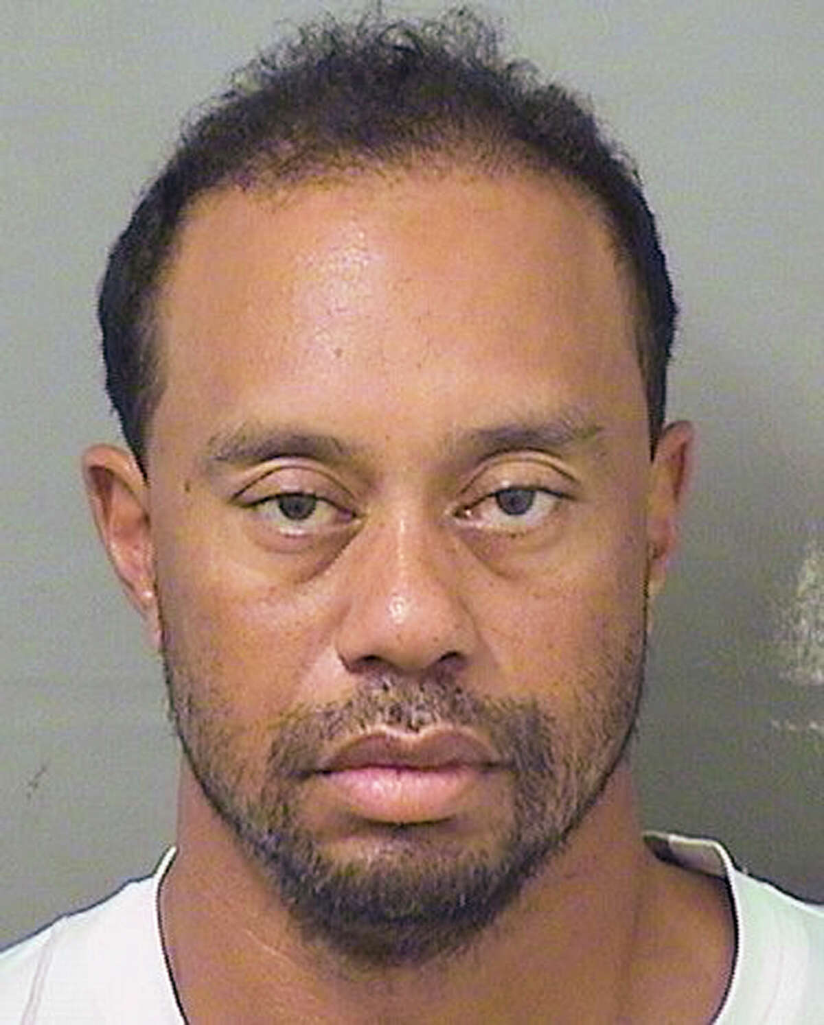 Tiger Woods is in a disheveled state in the booking photo from his DUI arrest.