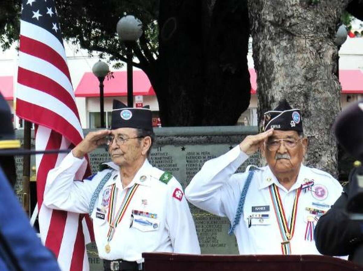 Korean War Veterans Ernesto Sanchez and Nicolas Nanez salute as members of the Joint Group of Law Enforcement Honor Guard present the colors at the Memorial Day ceremony at Jarvis Plaza on Monday.