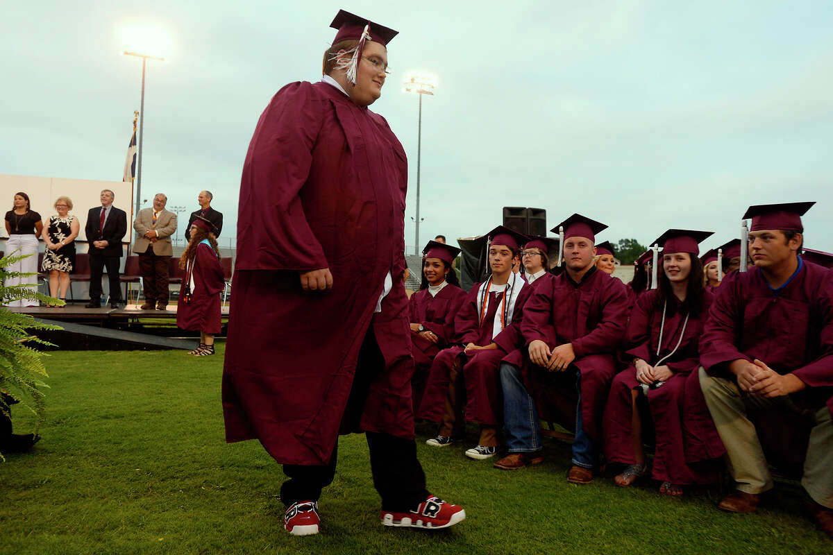 Dakota Martin walks to his seat before graduating from Silsbee High School on Friday evening. Martin battled cancer his sophomore year, and his family didn't know if he'd make it to graduation. Martin is in remission. Photo taken Friday 5/26/17 Ryan Pelham/The Enterprise