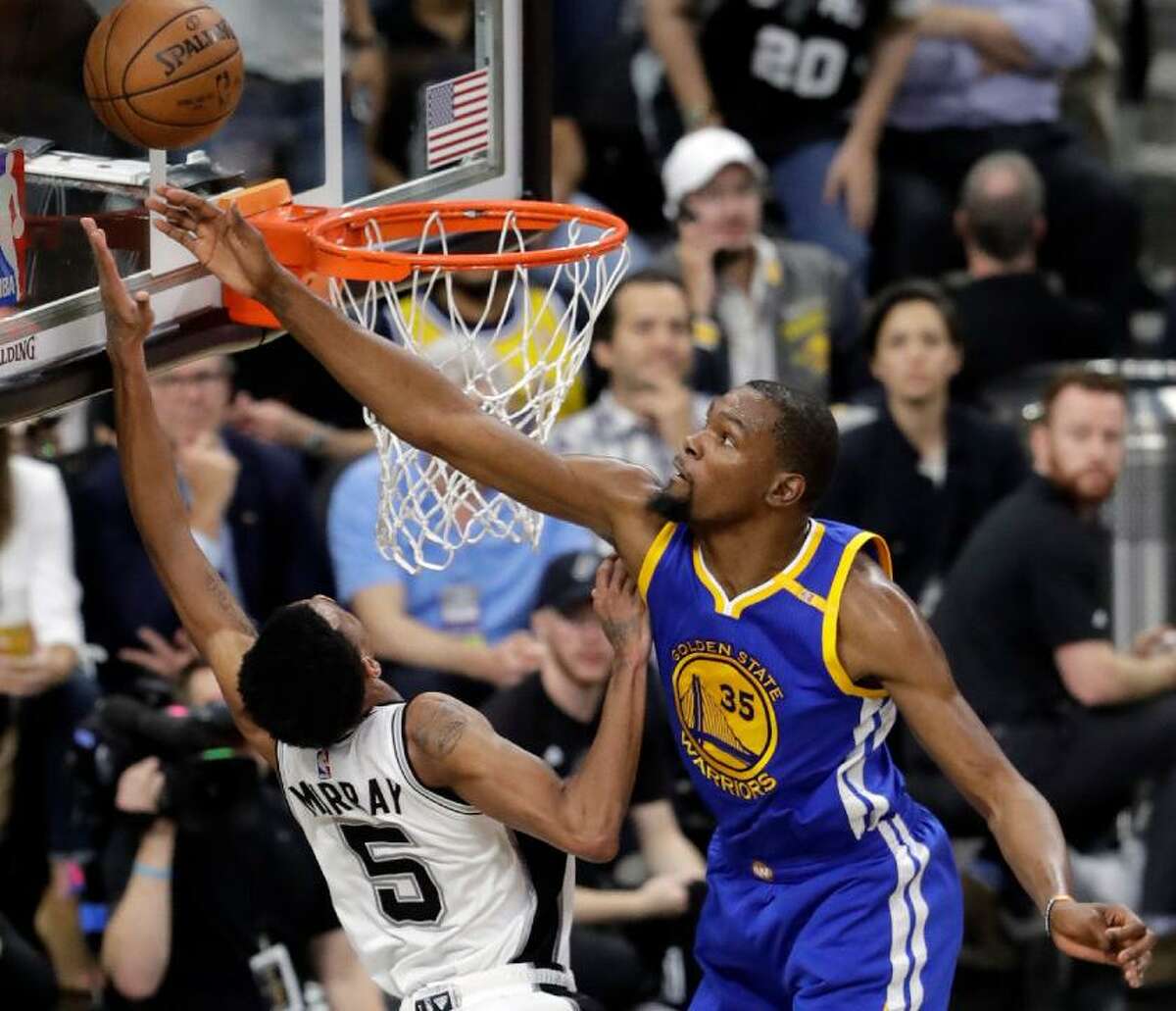 Spurs guard Dejounte Murray (5) has his shot blocked by Golden State Warriors’ Kevin Durant (35) during the first half in Game 4 of the Western Conference finals on May 22, 2017, in San Antonio.