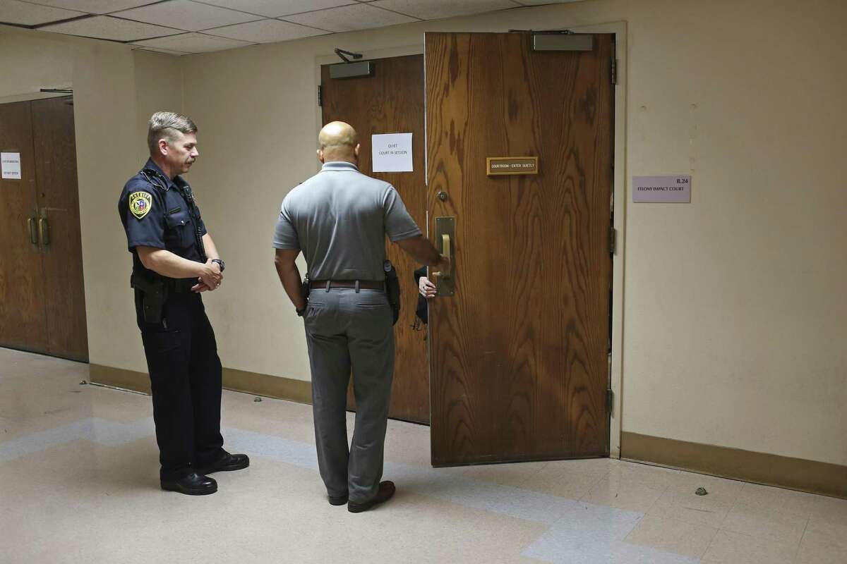 A San Antonio Police Department witness enters the Bexar County Impact Court in the basement of the Bexar County Courthouse, Monday, May 8, 2017. Judge Laura Parker presides over the court that is designed to take some of the cases from courts that have huge dockets while also reducing the overpopulation problem at the Bexar County Jail.