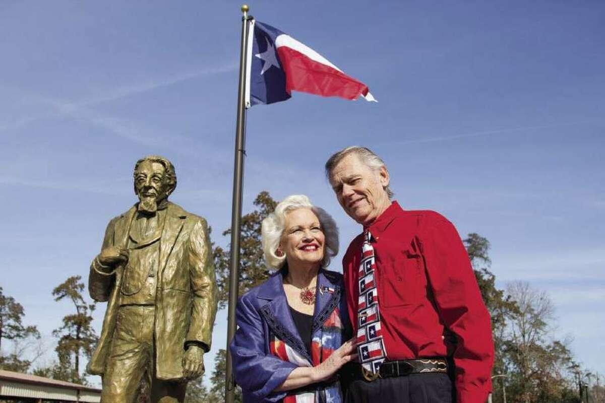 Great-great-great granddaughter of Charles B. Stewart, Pat Spackey and her husband, Ted, stand next to a bronze statue of Stewart during the unveiling of the statue and a 175th birthday of the Lone Star flag celebration at Cedar Brake Park in Montgomery in 2014.
