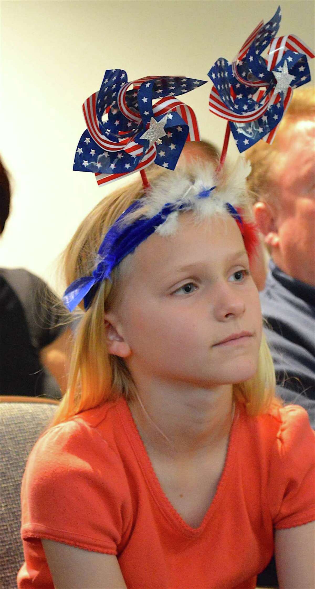 Avery Burnham, 8, of Fairfield observes the ceremony at the Memorial Day celebration in Town Hall, Monday, May 29, 2017, in Westport, Conn.