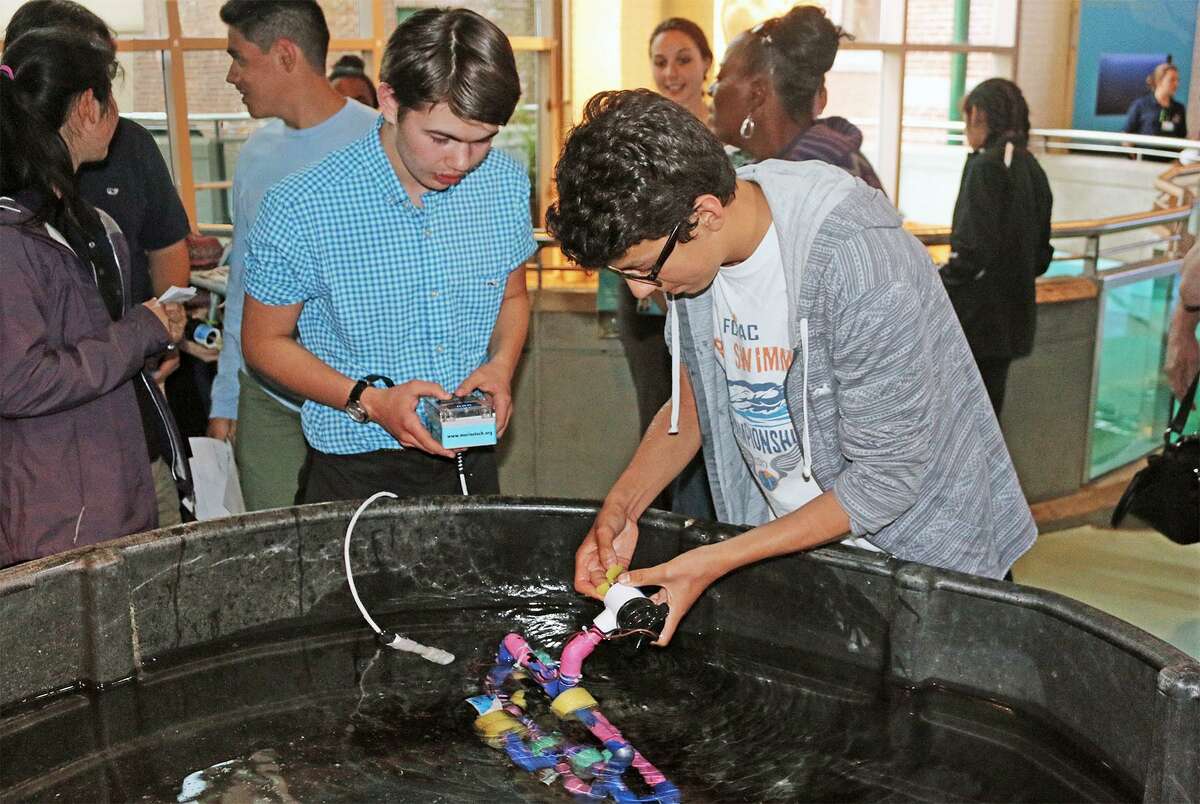 Michael Suarez, left, a freshman at Norwalk High School, and Max Parizot, a freshman at Brien McMahon High School, prepare to demonstrate their underwater remotely operated vehicle (ROV) during the May 24 end-of-year celebration for teens participating in the TeMPEST after-school program at The Maritime Aquarium at Norwalk.