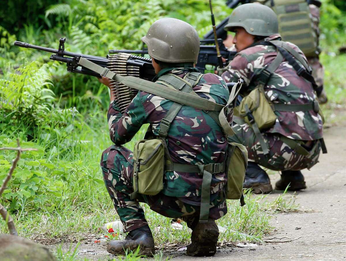 Government troops take positions as fighting with Muslim militants in Marawi city enters its second week Tuesday, May 30, 2017, in southern Philippines. Philippine forces pressed their offensive to drive out militants linked to the Islamic State group after days of fighting left corpses in the streets and hundreds of civilians begging for rescue from a besieged southern city of Marawi. (AP Photo/Bullit Marquez)