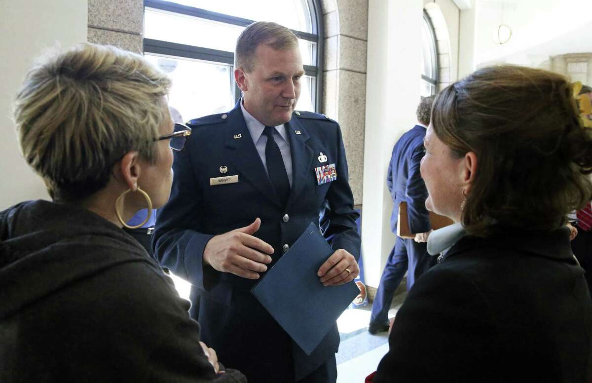Representing Joint Base San Antonio, Col. Jonathan Wright chats in the halls with his wife Lisa Wright (left) and counsel Mary Mulhearn (also with Joint Base San Antonio) as committee hearings on annexation bills are delayed by legislative work in the two chambers of the Capitol in Austin on April 5, 2017.