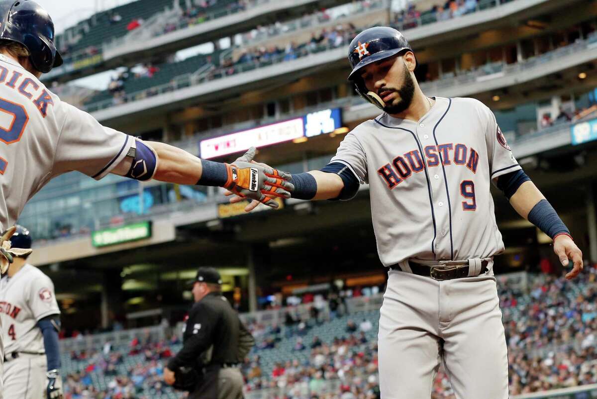 Houston Astros' Marwin Gonzalez, right, is congratulated by Josh Reddick after he scored on a sacrifice fly by Alex Bregman in the third inning of a baseball game Tuesday, May 30, 2017 in Minneapolis. (AP Photo/Jim Mone)