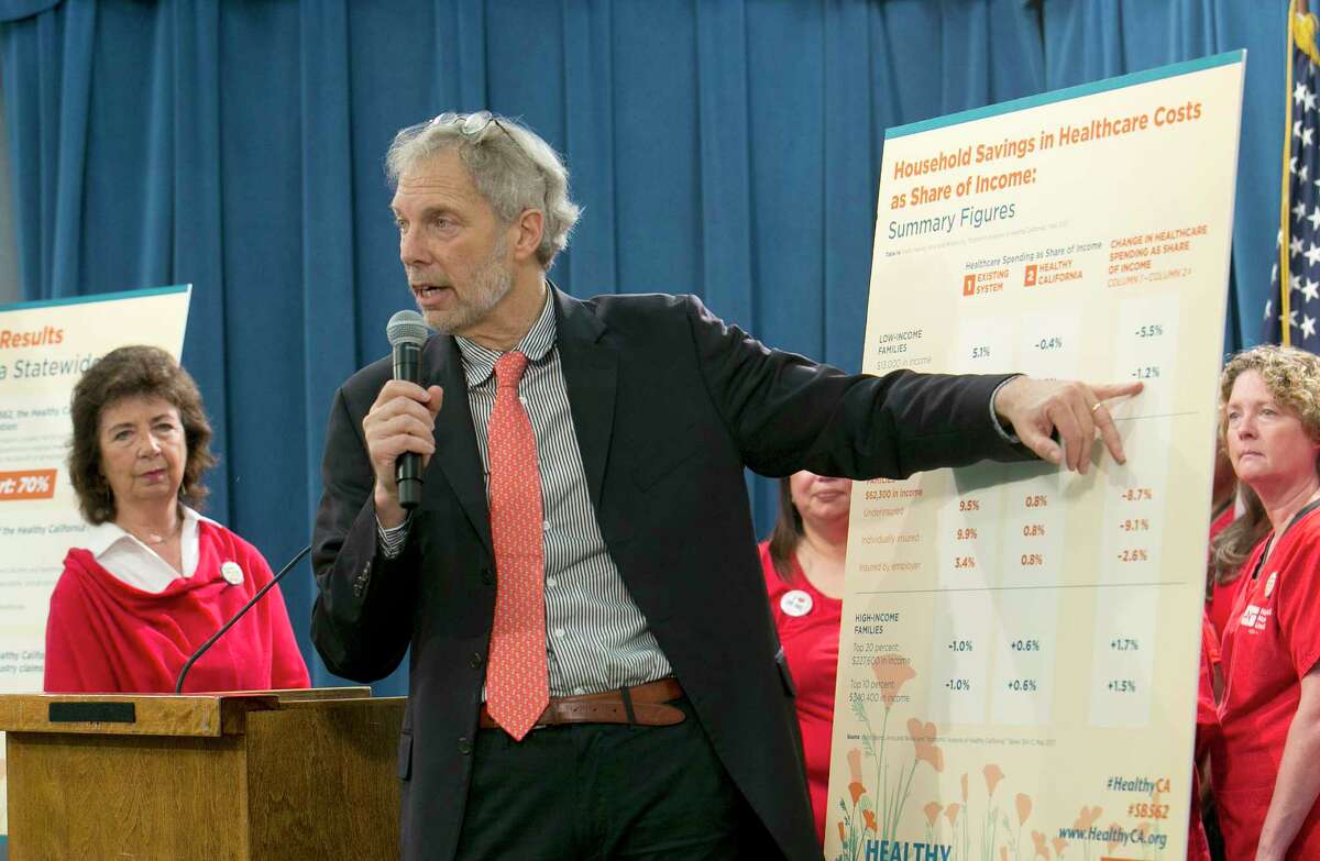 Professor Robert Pollin, a researcher from the University of Massachussetts-Amherst, gestures to a chart showing estimates of cost savings if a proposed single-payer health care bill was approved by the Legislature, during a news conference, Wednesday, May 31, 2017,in Sacramento, Calif. A report released by the California Nurses Association, done by Pollin and others, suggests that a 2.3 precent sales tax and a 2.3 precent gross receipts tax would help cover the additional costs to provide health care for all Californians.