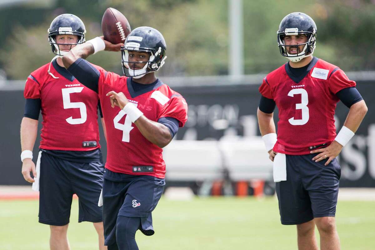 Houston Texans quarterback Deshaun Watson (4) throws a pass, with Brandson Weeden (5) and Tom Savage (3) looking on, during OTAs at The Methodist Training Center on Wednesday, May 31, 2017, in Houston.