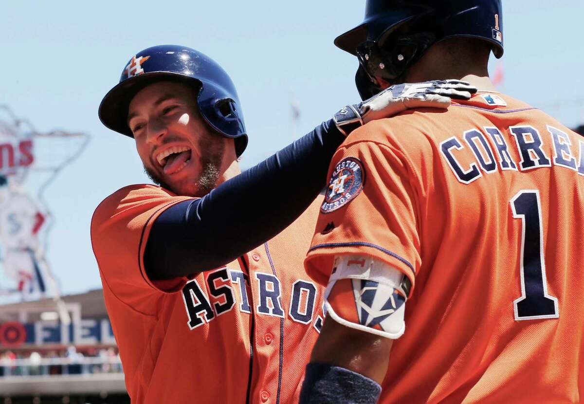 Houston Astros' George Springer, left, celebrates his solo home run off Minnesota Twins pitcher Hector Santiago with Carlos Correa in the fifth inning of a baseball game Wednesday, May 31, 2017 in Minneapolis. Correa homered in the first inning. (AP Photo/Jim Mone)
