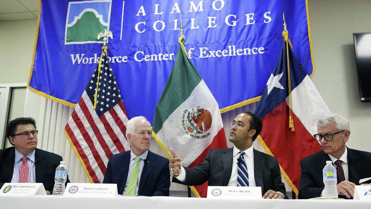 U.S. Sen. John Cornyn listens as U.S. Rep. Will Hurd makes a point as they attend a panel discussion on Texas-Mexico trade at the Atrium Conference Center of the Alamo Colleges . On the left is Texas Secretary of State Rolando Pablos On the right is Tryon Lewis, Chairman of the Texas Transportation Commission.