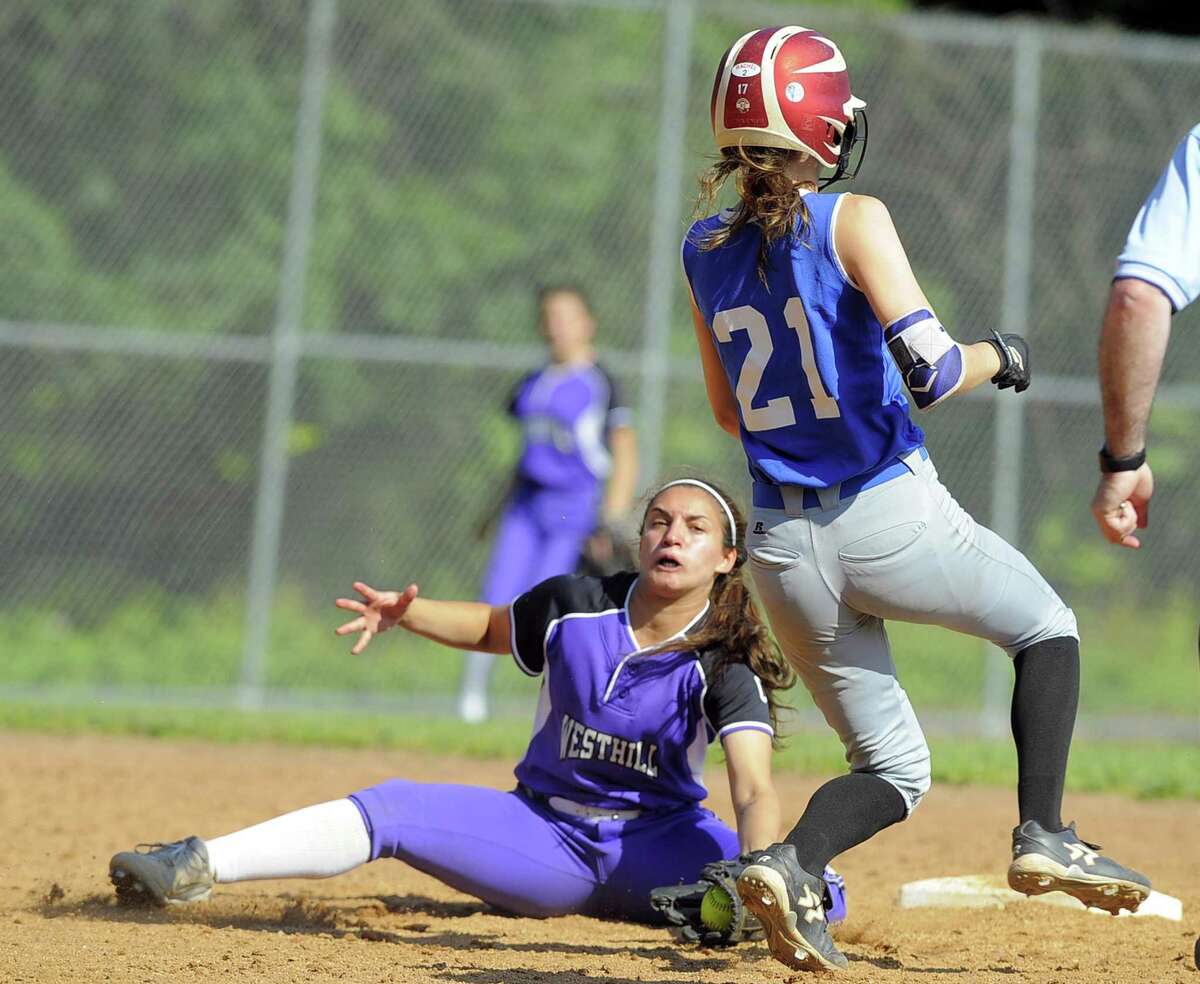 Westhill Gabby Laccona looks to tag out Glastonbury Julia Karnes on a third inning stolen base in a second round CIAC Class LL softball game at Westhill High School in Stamford, Conn. on Tuesday, May 31, 2017. Karnes was called safe on the play and later scored a run.