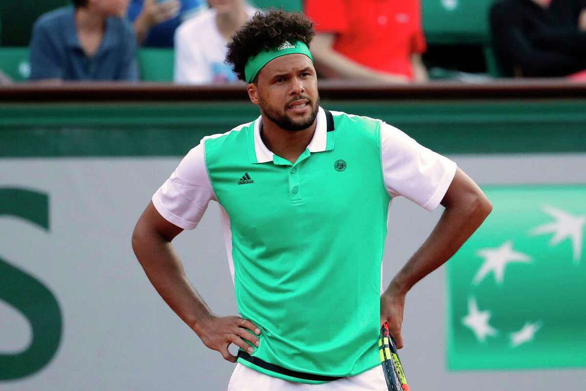 France's Jo-Wilfried Tsonga reacts during his tennis match against Argentina's Renzo Olivo at the Roland Garros 2017 French Open on May 30, 2017 in Paris. / AFP PHOTO / Thomas SAMSONTHOMAS SAMSON/AFP/Getty Images