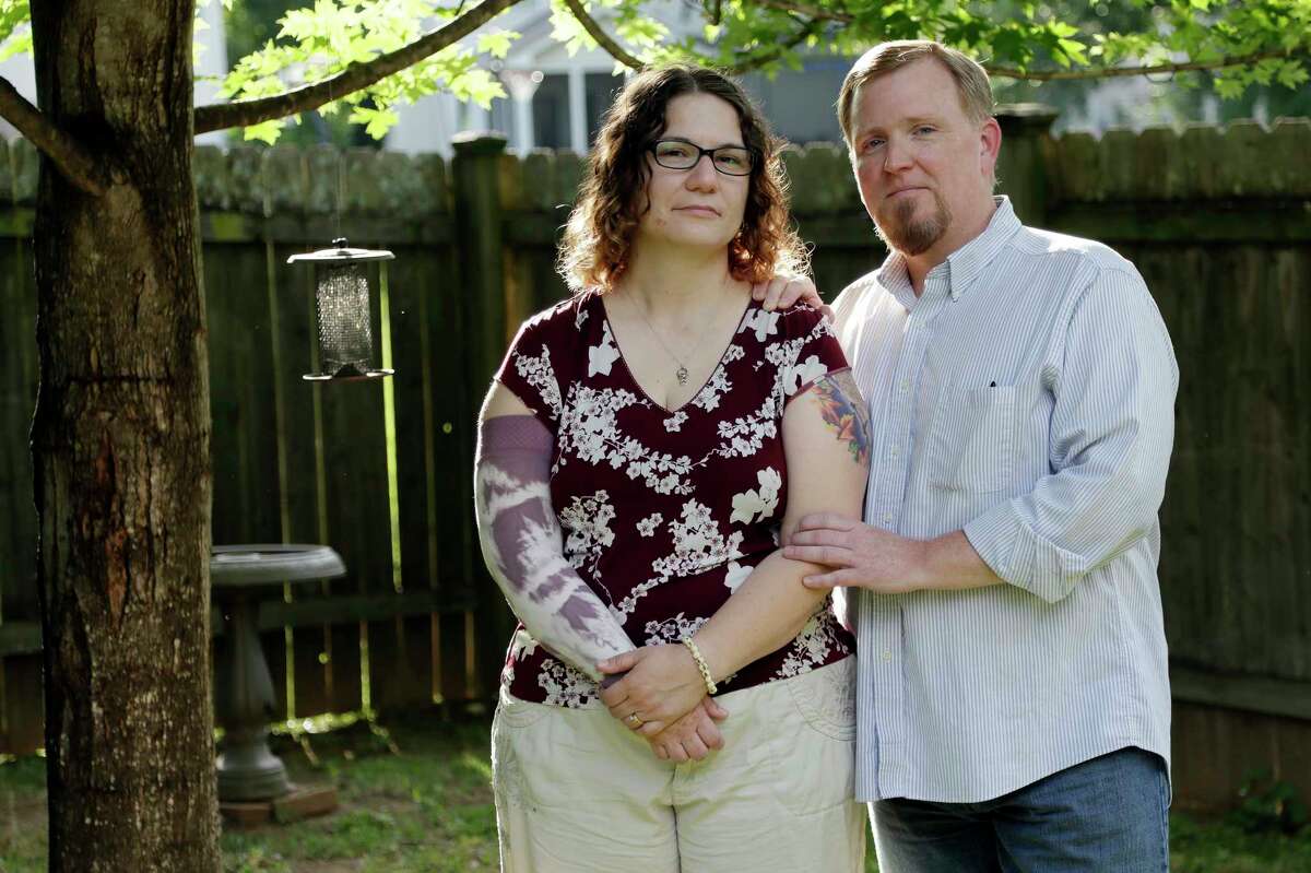 In this May 26, 2017 photo, Lisa Dammert and her husband, Patrick, pose at their home in Franklin, Tenn. As a thyroid cancer survivor battling nerve damage and other complications, Lisa was in such dire financial straits in 2014 that she and her husband let their health insurance lapse, putting them in a category with some 6 million Americans who have gone without coverage at times despite serious health problems. That group and millions of others who have had a gap in insurance could face higher charges under the Republican health care bill that recently passed the House. (AP Photo/Mark Humphrey)