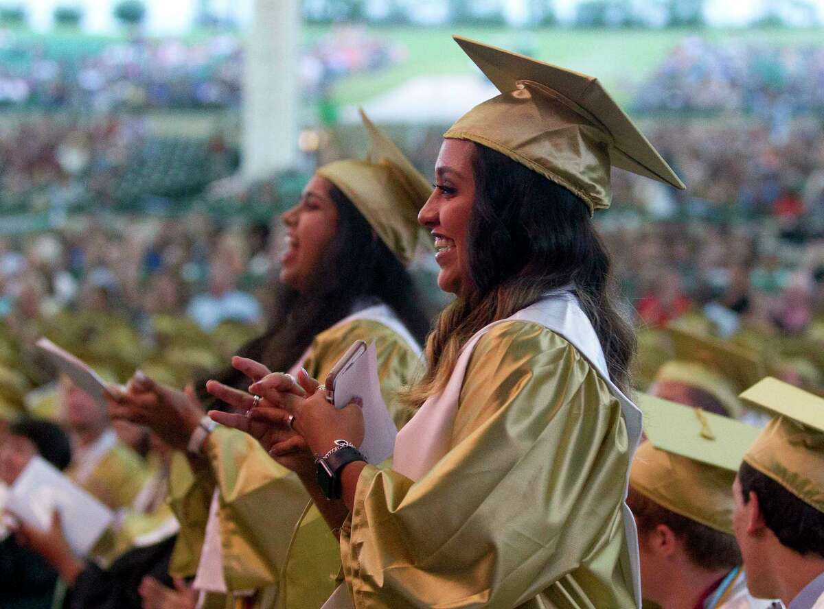 Alyssa Bernald and Annanya Chaturvedi cheer during a Conroe High School graduation ceremony at Cynthia Woods Mitchell Pavilion, Tuesday, May 30, 2017, in The Woodlands.