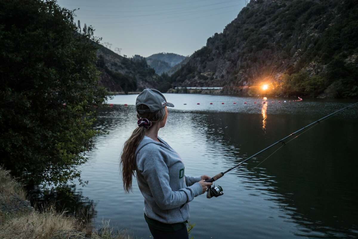 Debbie Regan of Oakdale watches a train while fishing in a PG&E reservoir on SR 70 on Sunday, May 28 2017 in Plumas County, CA