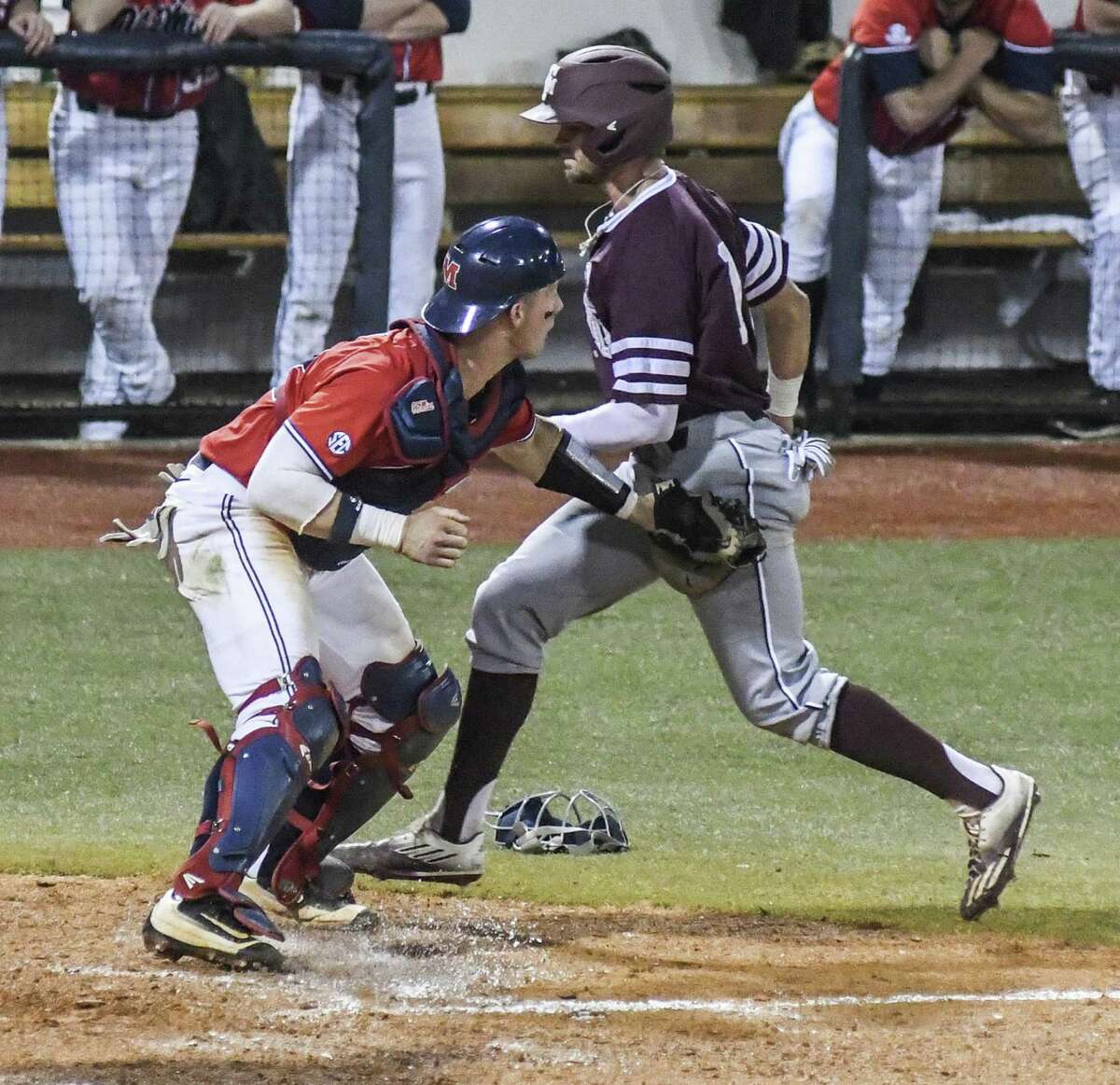 Mississippi’s Cooper Johnson (left) tags out Texas A&M’s Blake Kopetsky at the plate during an SEC on May 13, 2017, in Oxford, Miss.