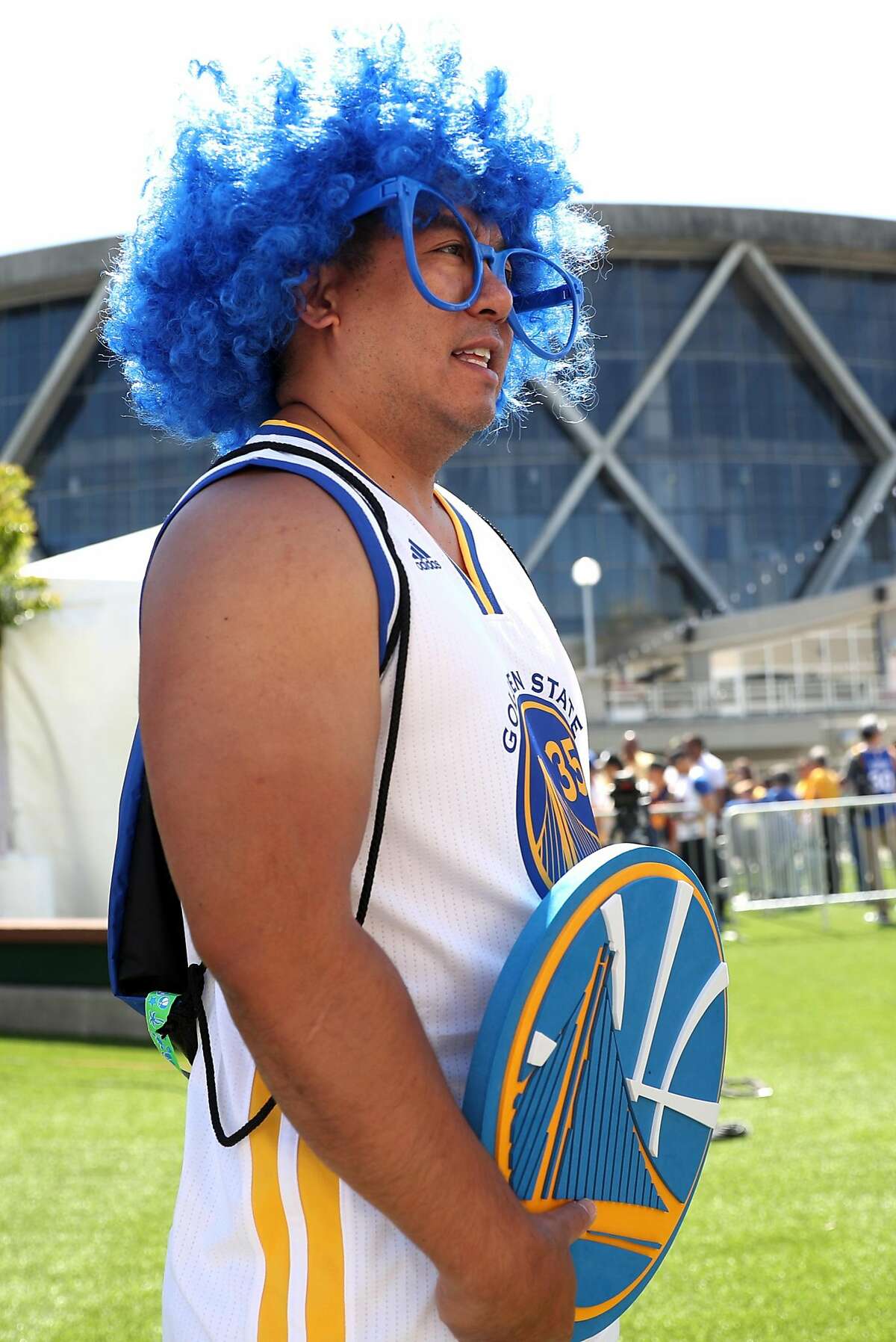 Golden State Warriors' fan Phil Eugenio of Union City waits in line to get a souvenir lanyard before Game 1 of the NBA Finals at Oracle Arena in Oakland, Calif., on Thursday, June 1, 2017.
