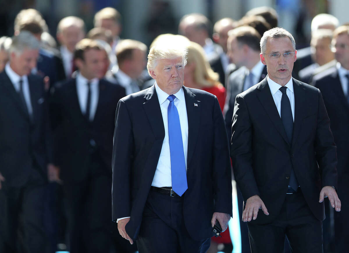 President Donald Trump, left, with beside NATO Secretary General Jens Stoltenberg in front of other world leaders at NATO headquarters in Brussels, Belgium, on May 25, 2017. (Jasper Juinen/Bloomberg)
