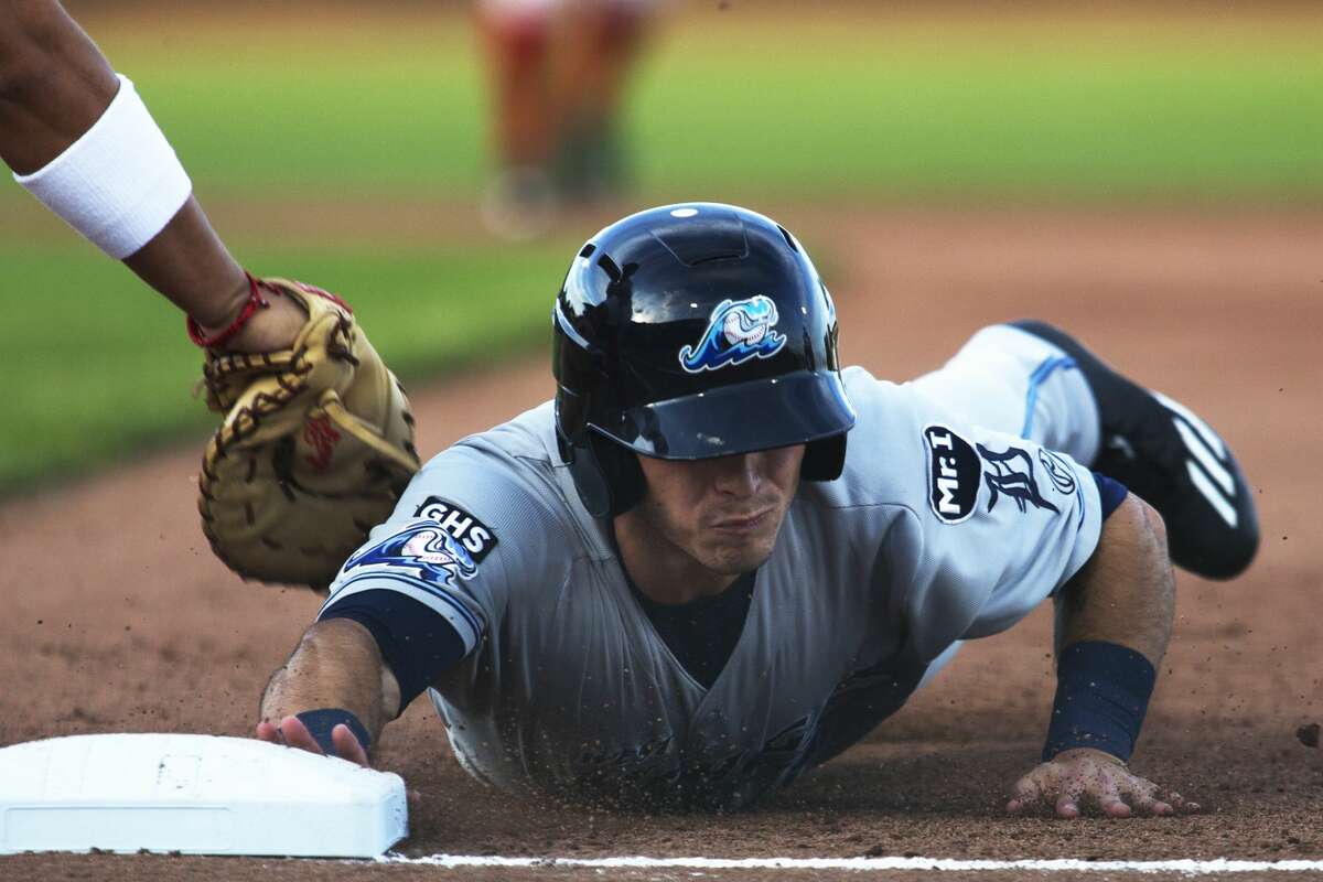The Great Lakes Loons infielder Erick Meza attempts to tag West Michigan Whitecaps Jacob Robson in a game at Dow Diamond on Thursday.
