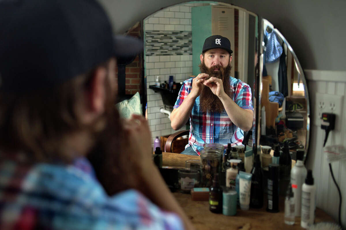 BRITTNEY LOHMILLER | blohmiller@mdn.net Scott Pawlak of Midland poses for a portrait at his home Friday morning. Pawlak won the overall best beard during the second Battle of the Beards on May 11 at Albert's General Store in Bay City. He hasn't shaved in 15 months and this is the longest beard he's grown. 'Cleaning shaving is a lot of work, having a beard is a lot of work too but I don't have to shave every day like I would if I wanted to be clean shaved,' Pawlak said.