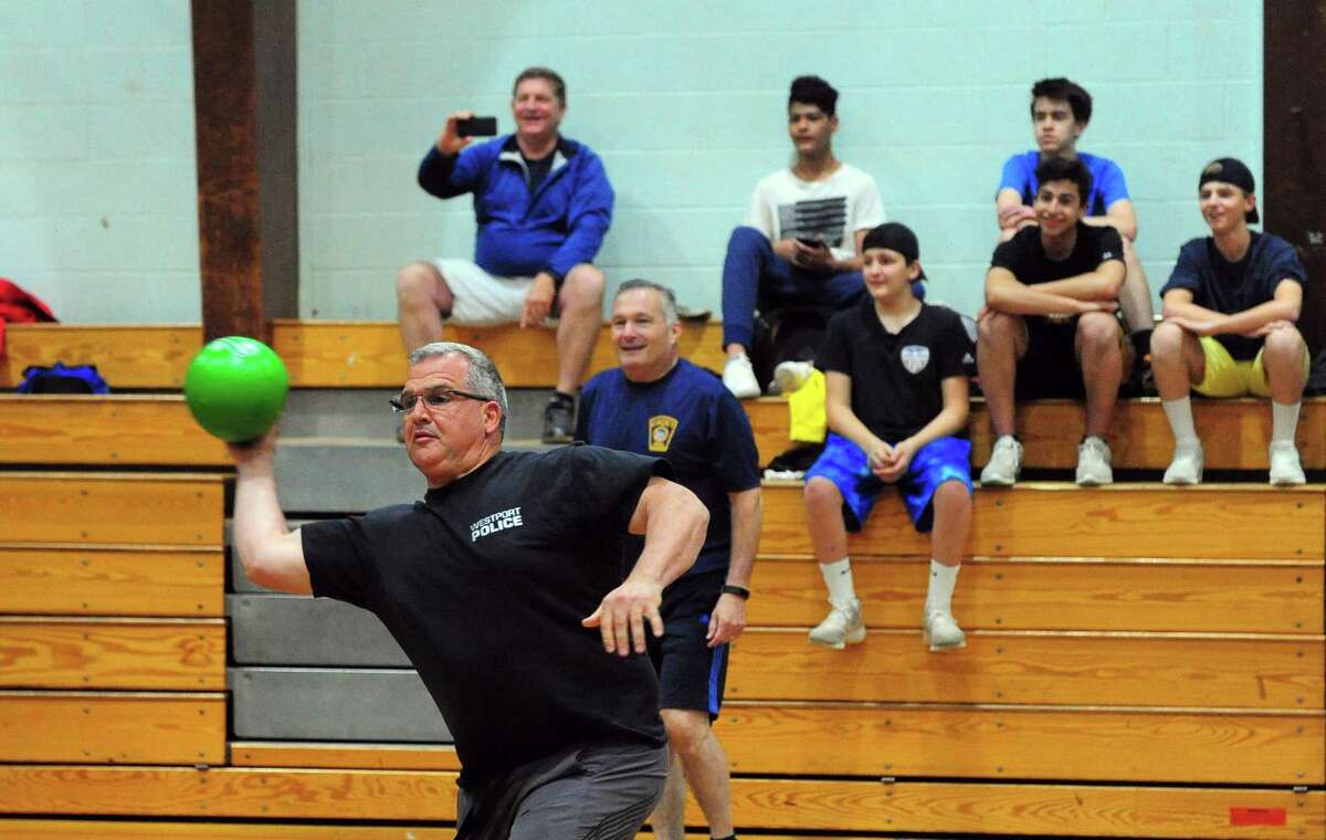 Westport Police Chief Foti Koskinas plays dodgeball with Trumbull High School students in the first ever Dodge-a-Cop Dodgeball Tournament at Hillcrest Middle School in Trumbull, Conn., on Thursday May 25, 2017. Trumbull Police Department officers joined with students with Trumbull High School, the Trumbull Recreation Department, and TPAUD (Trumbull Partnership Against Underage Drinking) to participate in the event which serves as an opportunity to strengthen community ties and re-shape kid?’s perspective on the police. TPAUD hopes to turn the tournament into an annual event.
