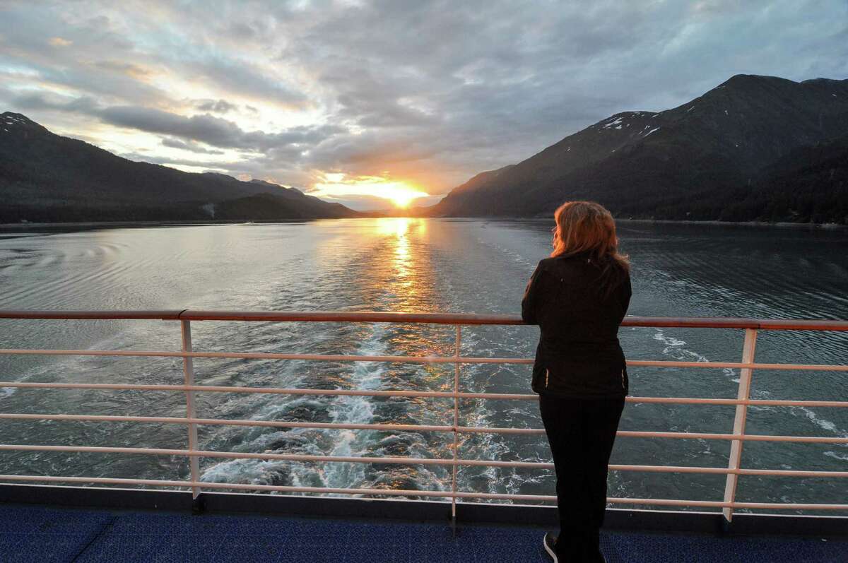 The sunset fades into the distance from the aft deck of the Coral Princess departing Juneau, Alaska﻿.
