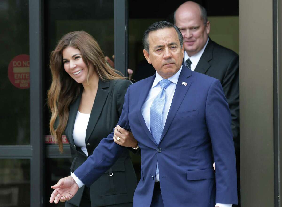 Senator Carlos Uresti, foreground right, walks out of the Federal Courthouse with his wife Lleanna Uresti, left, and attorney Mikal Watts, background right, following his arrest by the FBI on Wednesday, May 17, 2017.