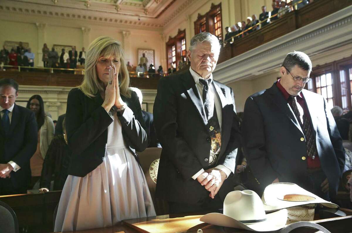 Rep. Doc Anderson listens to the benediction with son Thomas Anderson and fiancée Lynn Sullivan as the 85th Texas Legislative session opens in Austin on Jan. 10. Texas state lawmakers filed more bills this session than almost any other in state history. But despite the higher number of bills they proposed, lawmakers passed and sent fewer bills to the governor than it has in more than two decades.
