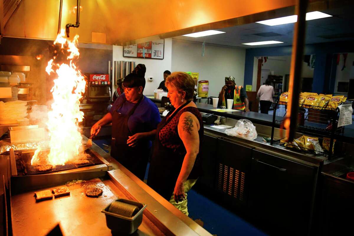 Houston International Seafarers' Center cook Ethel Berry, left, who has worked at the center for 23 years, and executive assistant Jerri Parker, prepare some of the last burgers on the grill as the Seafarers' center is closing to relocate to a smaller building Thursday, June 1, 2017 in Houston. ( Michael Ciaglo / Houston Chronicle )