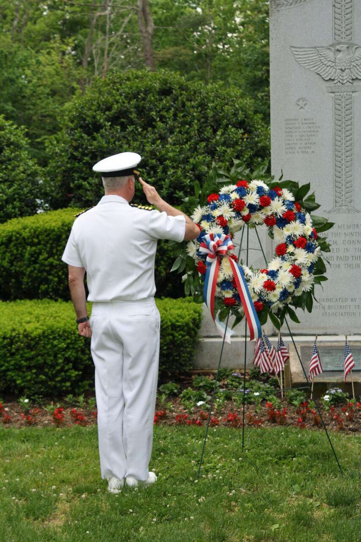 U.S. Navy Capt. Mark Turner, a town resident, salutes a wreath at the Glenville memorial for its annual Memorial Day parade and ceremony.