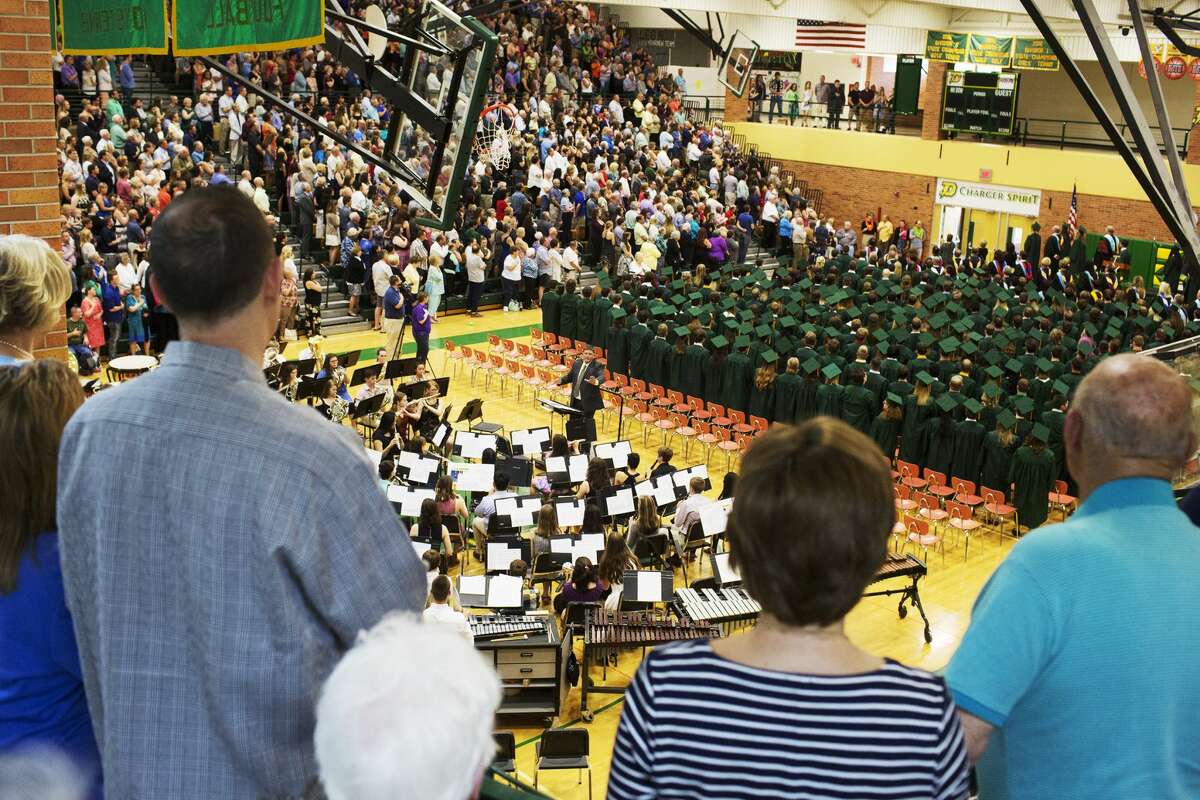 Dow High School Chamber Singers and School Band perform the National Anthem at the start of commencement on Friday.