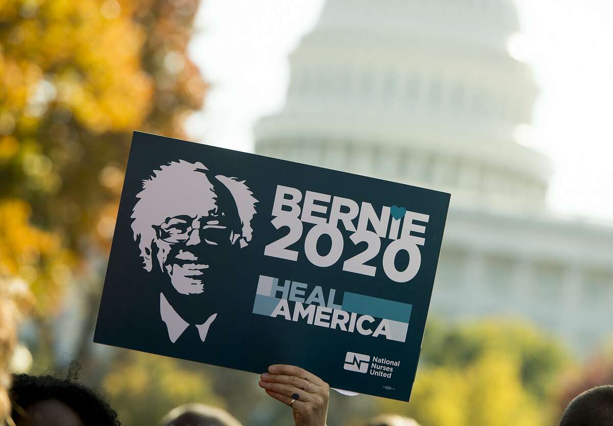 A supporter of US Senator Bernie Sanders(I-VT), holds up a "Bernie 2020" sign as he speaks during a rally to stop the Trans-Pacific Partnership (TPP) organized by National Nurses United and the People for Bernie Sanders, on Capitol Hill in Washington, DC, November 17, 2016. / AFP PHOTO / SAUL LOEBSAUL LOEB/AFP/Getty Images