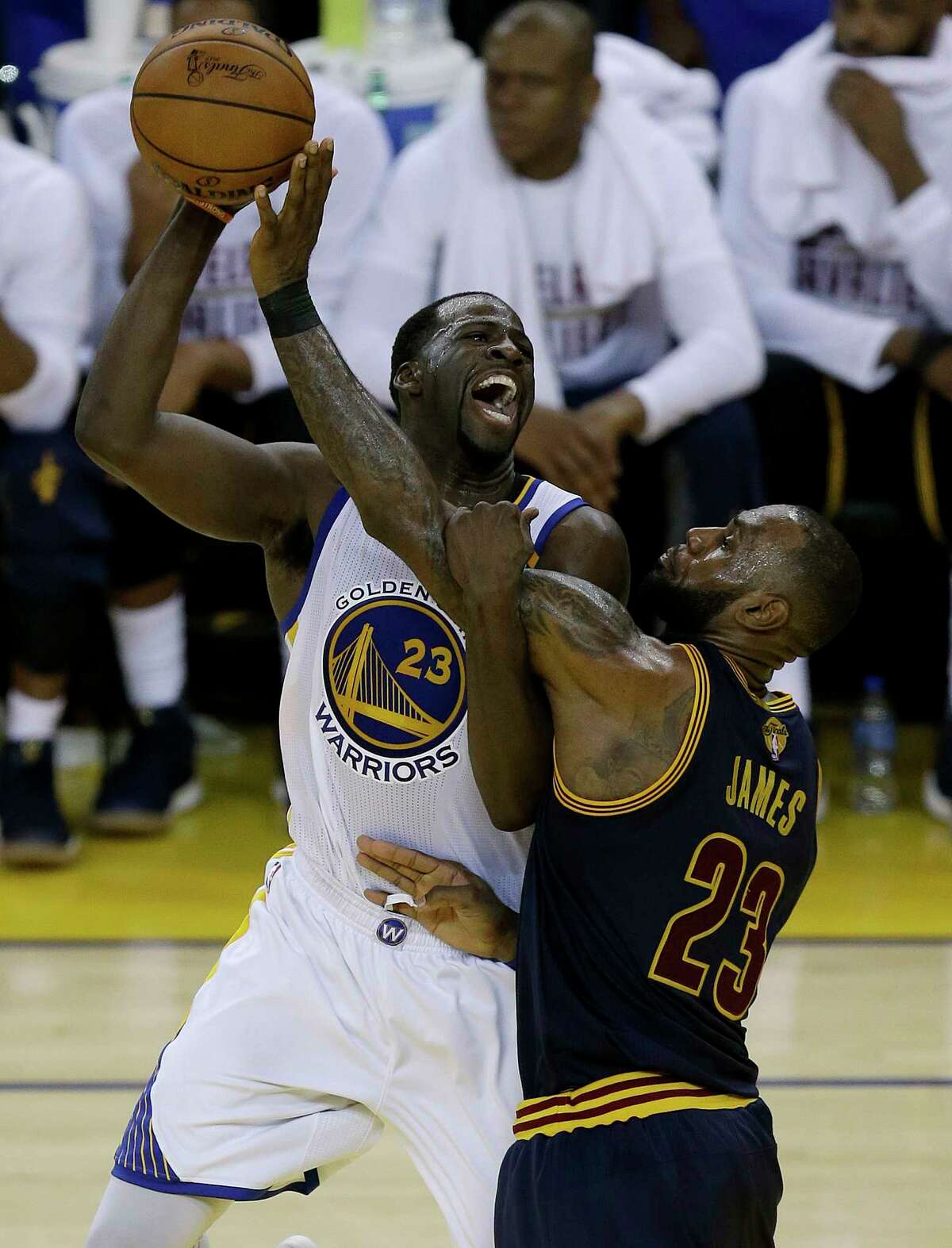 Golden State Warriors forward Draymond Green, left, shoots against Cleveland Cavaliers forward LeBron James during the second half of Game 1 of basketball's NBA Finals in Oakland, Calif., Thursday, June 1, 2017. (AP Photo/Ben Margot)