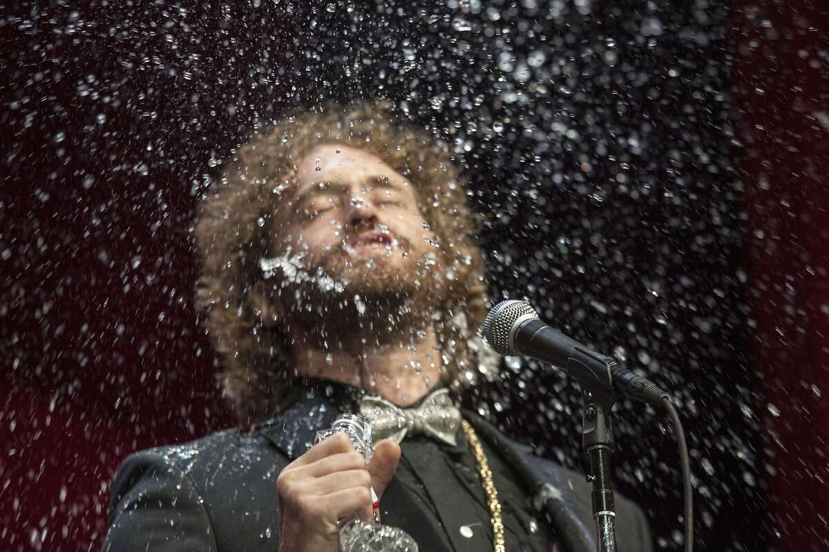 TJ Miller sprays himself with bottle of water during his set at the Bill Graham Civic Auditorium during Colossal Clusterfest in San Francisco, June 2, 2017. (Peter DaSilva/Special to The Chronicle)