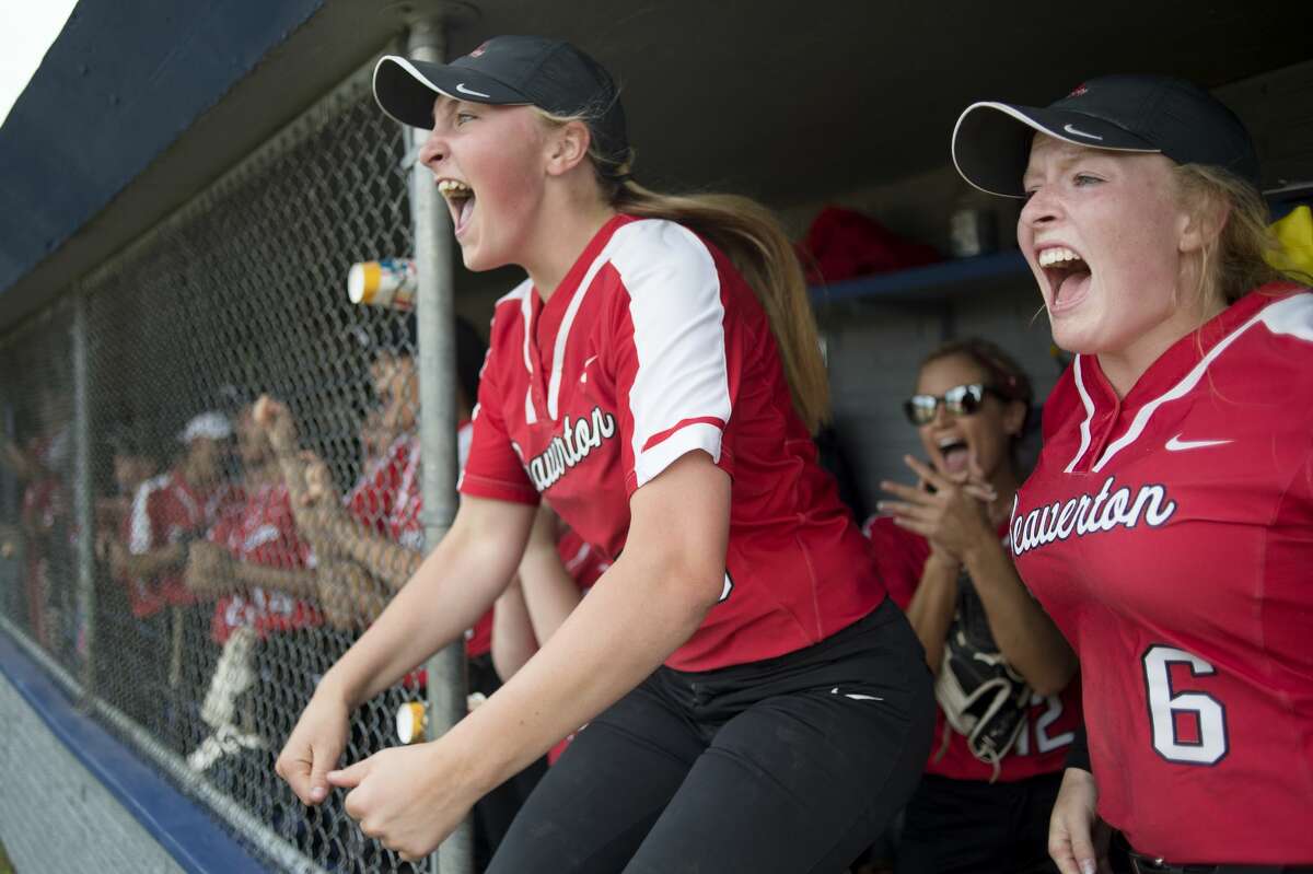 Beaverton's Ann-Marie Hicks, left, and Faith Howe celebrate as Maddy Krauss scores Beaverton's second run in the fourth inning of Beaverton's game against Farwell in the Division 3 softball tournament Saturday morning. Beaverton defeated Farwell 3-0.