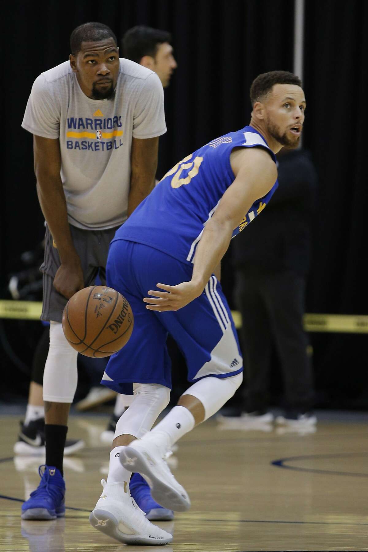 Golden State Warriors guard Stephen Curry (30) and forward Kevin Durant (35) practice together at the Warriors practice facility on Saturday, June 3, 2017, in Oakland, Calif. In the NBA Finals, the Warriors lead the series 1-0 against the Cleveland Cavaliers. They play Game 2 on Sunday.