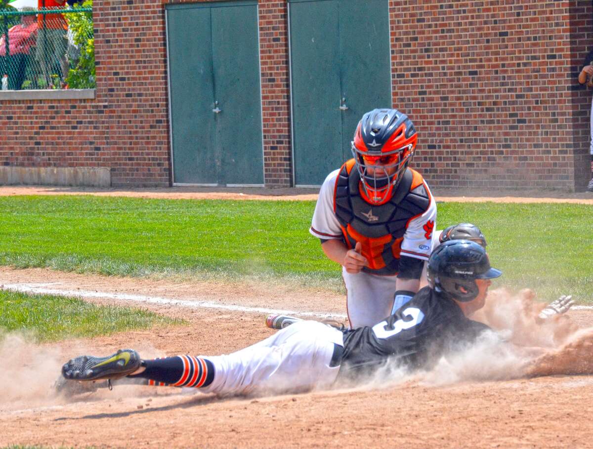 Edwardsville catcher Dalton Wallace tags out Andrew Kurdys at home plate for the second out of the second inning in Saturday’s sectional championship at Illinois Wesleyan University in Bloomington.
