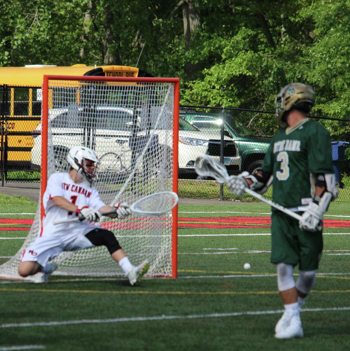 New Canaan goalie Drew Morris knocks away a shot during the Class M lacrosse quarterfinals between New Canaan and Notre Dame-West Haven on Saturday at New Canaan High School. New Canaan defeated Notre Dame-West Haven 16-3.