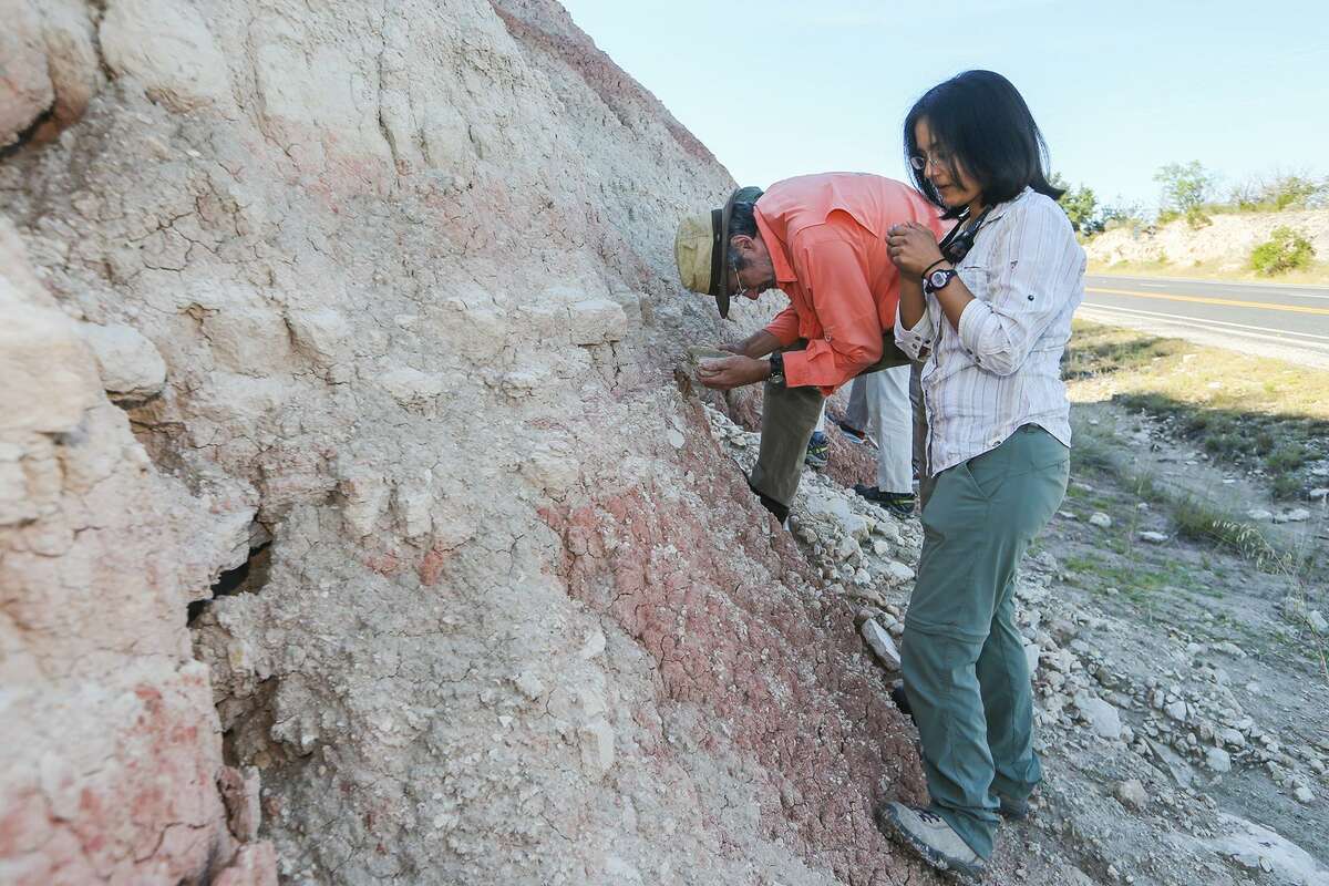 UTSA professor Marina Suarez (right) and Dan Lehrmann, professor of Geosciences at Trinity University, inspect soil samples from the Hensel formation, deposited during the Early Cretaceous period, from a roadcut along IH-10 just outside of Junction, TX, on Wednesday, May 24, 2017. Suarez was leading a team to collect soil samples in order to learn more about the climate of the period by analyzing the ratio of carbon isotopes in the rocks. MARVIN PFEIFFER/ mpfeiffer@express-news.net