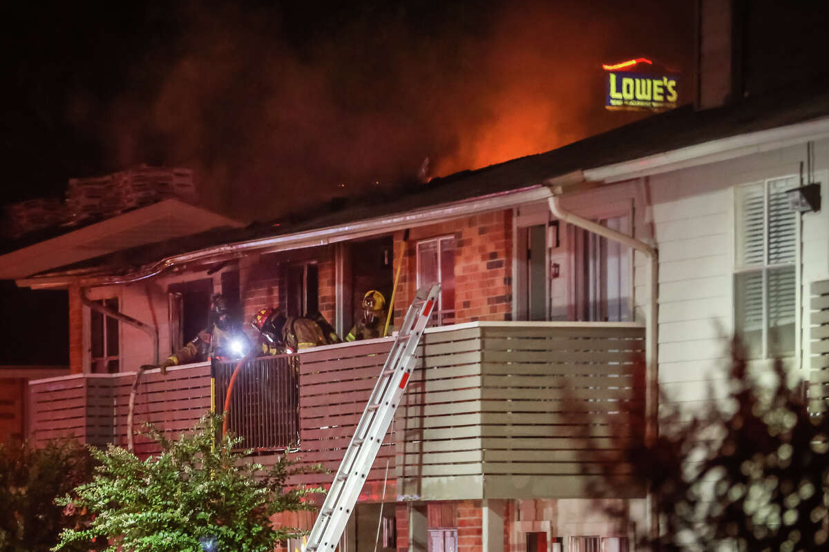 Firefighters battle a fire, believed to have been sparked by lightning, that destroyed multiple apartment units on Saturday, June 3, 2017, at Autumnwood Apartments in Conroe.