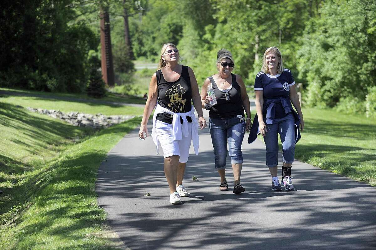 From left, sisters Susan White, of Brookfield, Patti Giddings of New Milford and Bonnie Saumell of Danbury, go for a morning walk together on the Still River Greenway Friday, June 2, 2017.